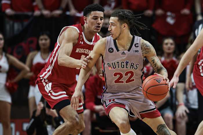 Rutgers Scarlet Knights guard Caleb McConnell (22) dribbles against Wisconsin Badgers guard Johnny Davis (1) during the first half at Jersey Mike's Arena.